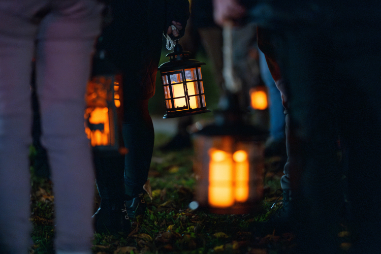 Photo of visitors walking outside with lanterns